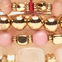 Close-up of a gold and pink beaded bracelet